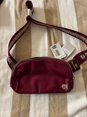 lululemon athletica Maroon Crossbody Belt Bag with Metallic Logo Strap